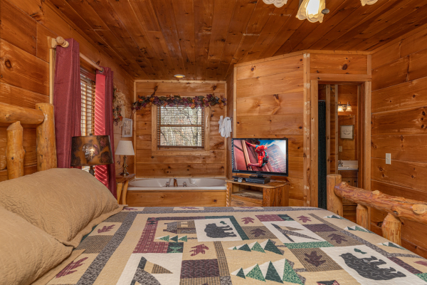 Bedroom with a TV and jacuzzi at Fallin' in Love, a 1 bedroom cabin rental located in Gatlinburg