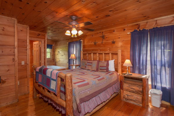 Bedroom with a log bed, night stands, and lamps at Patriot Inn, a 1 bedroom Gatlinburg cabin rental