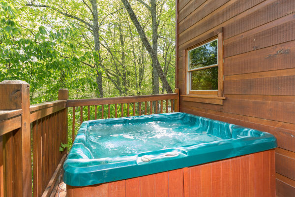 Hot tub on a deck at Patriot Inn, a 1 bedroom Gatlinburg cabin rental