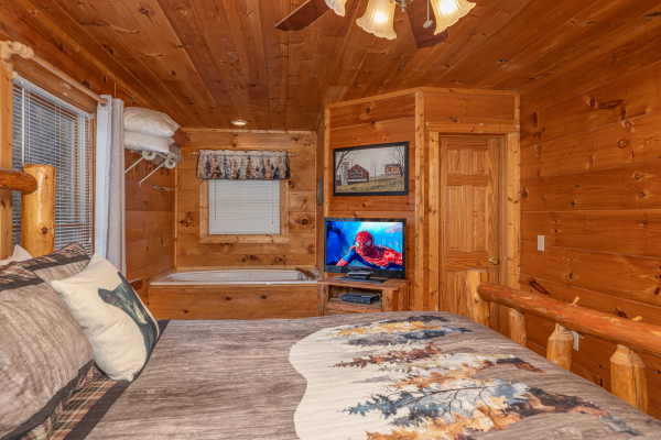 TV and jacuzzi in a bedroom at Just You and Me Baby, a 1 bedroom cabin rental located in Gatlinburg