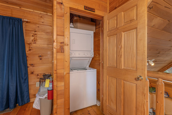 Stacked washer and dryer in a closet at Just You and Me Baby, a 1 bedroom cabin rental located in Gatlinburg