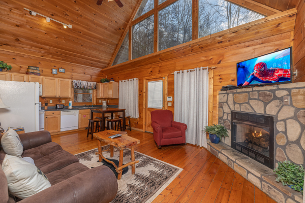 Living room with fireplace and TV at Just You and Me Baby, a 1 bedroom cabin rental located in Gatlinburg