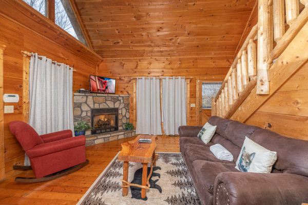 Fireplace and TV in a living room at Just You and Me Baby, a 1 bedroom cabin rental located in Gatlinburg