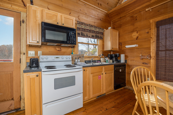 Kitchen stove at Deerly Beloved, a 1 bedroom cabin rental located in Pigeon Forge
