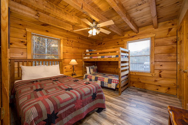 Queen bed and bunkbeds at Eagle's Loft, a 2 bedroom cabin rental located in Pigeon Forge