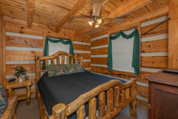 Bedroom with a log bed, night stand, and cabinet at Stellar View, a 1 bedroom cabin rental located in Pigeon Forge