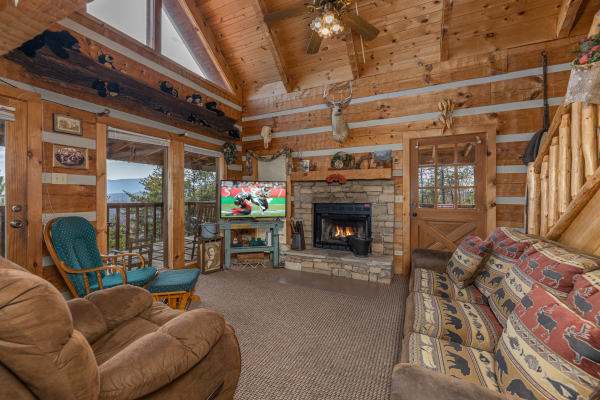 Fireplace and TV in a living room at Stellar View, a 1 bedroom cabin rental located in Pigeon Forge