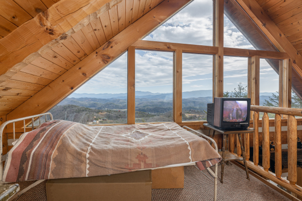 Bed and TV in the loft at Stellar View, a 1 bedroom cabin rental located in Pigeon Forge