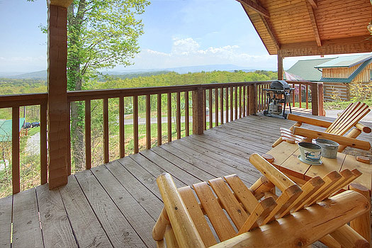 Log Adirondack seating on the deck at Do Not Disturb, a 1-bedroom cabin rental located in Pigeon Forge