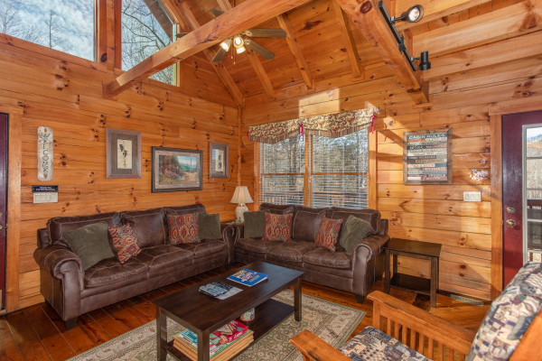 Living room with a sofa, loveseat, and vaulted ceiling at Shiloh, a 3 bedroom cabin rental located in Gatlinburg
