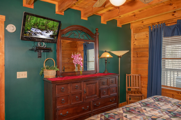 Bedroom with a dresser and TV at Shiloh, a 3 bedroom cabin rental located in Gatlinburg