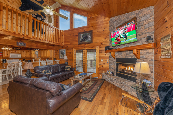 Living room with vaulted ceiling, fireplace, and TV at Almost Bearadise, a 4 bedroom cabin rental located in Pigeon Forge