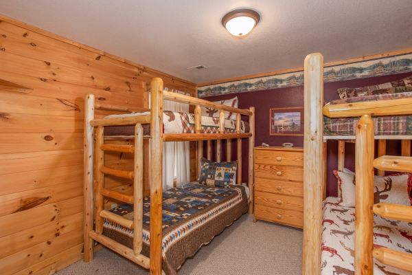 Two sets of twin-sized log bunk beds at Bearly in the Mountains, a 5-bedroom cabin rental located in Pigeon Forge