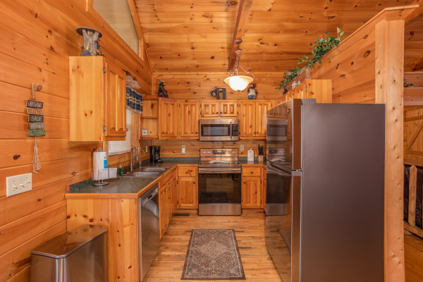 Kitchen with stainless steel appliances at Bearly in the Mountains, a 5-bedroom cabin rental located in Pigeon Forge