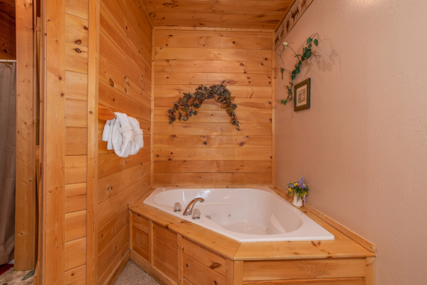 Jacuzzi tub in corner of bedroom at Bearly in the Mountains, a 5-bedroom cabin rental located in Pigeon Forge
