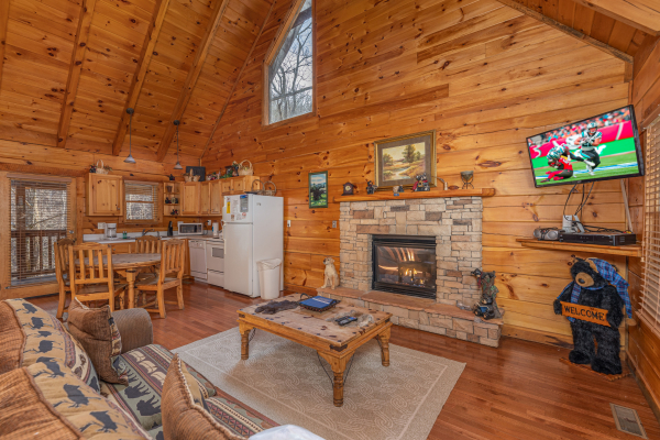 Living room with fireplace and TV at Smoky Bears Creek, a 2 bedroom cabin rental located in Pigeon Forge