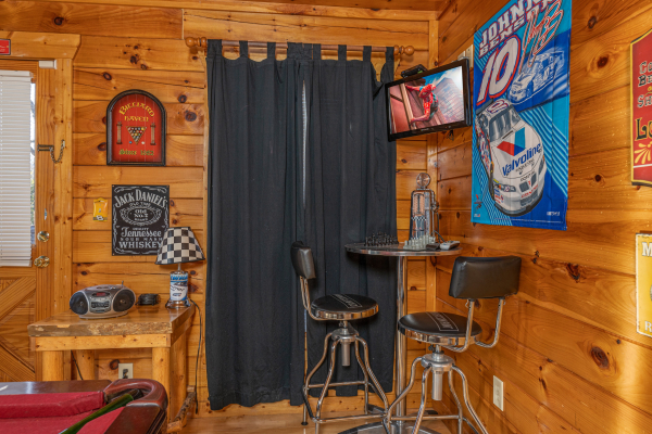 Bar table in the game room corner at Nascar Nation, a 2 bedroom cabin rental located in Pigeon Forge