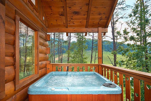 hot tub on a covered deck at always & forever a 1 bedroom cabin rental located in pigeon forge