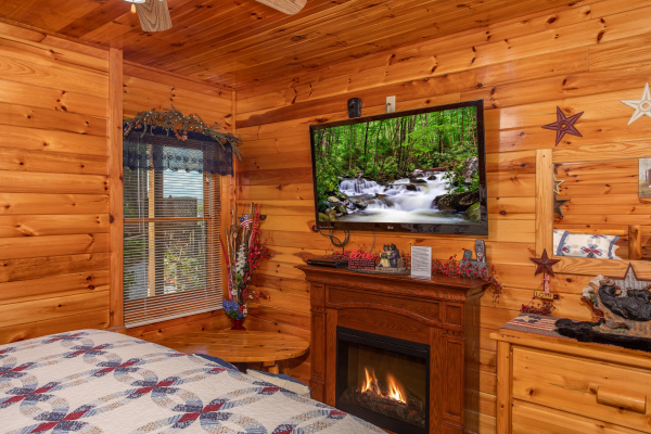Fireplace and flat screen television in a bedroom at Bear Country, a 3-bedroom cabin rental located in Pigeon Forge