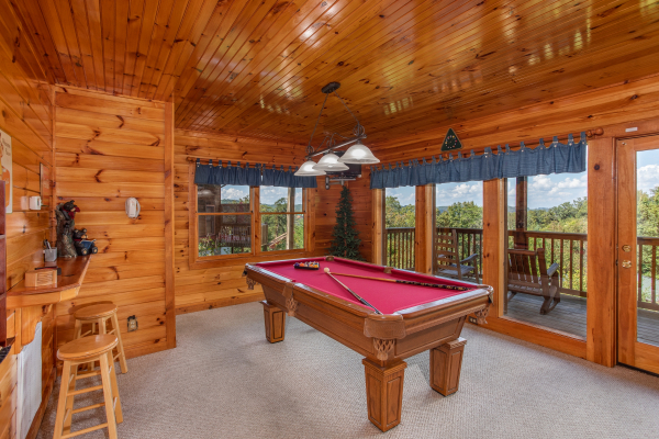 Red felted pool table at Bear Country, a 3-bedroom cabin rental located in Pigeon Forge
