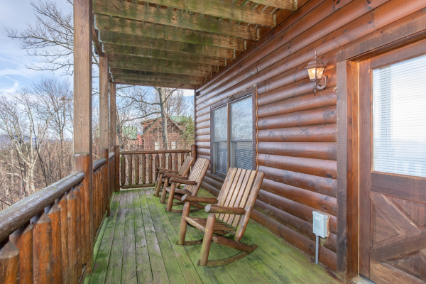 Covered deck with rocking chairs at 5 Star View, a 3 bedroom cabin rental located in Gatlinburg