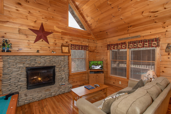 Fireplace and TV in the living room at Bearly Mine, a 1 bedroom Pigeon Forge cabin rental