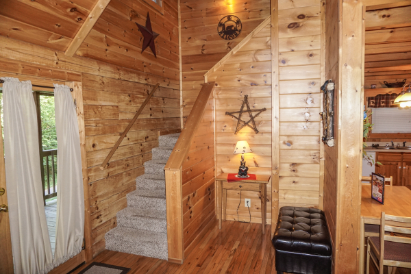 Staircase up to second floor at Bearly Mine, a 1-bedroom cabin rental located in Pigeon Forge