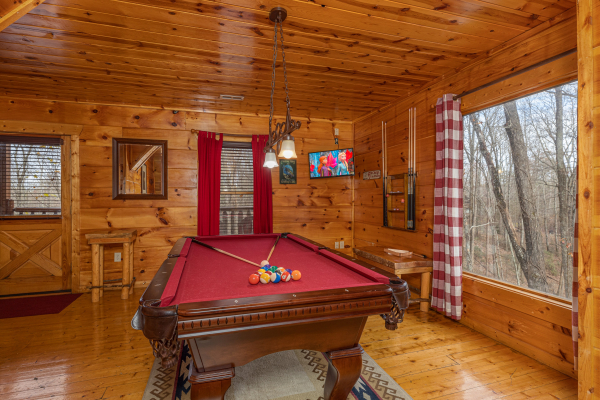 Red felt pool table in the game room at Dragonfly, a 2 bedroom cabin rental located in Gatlinburg