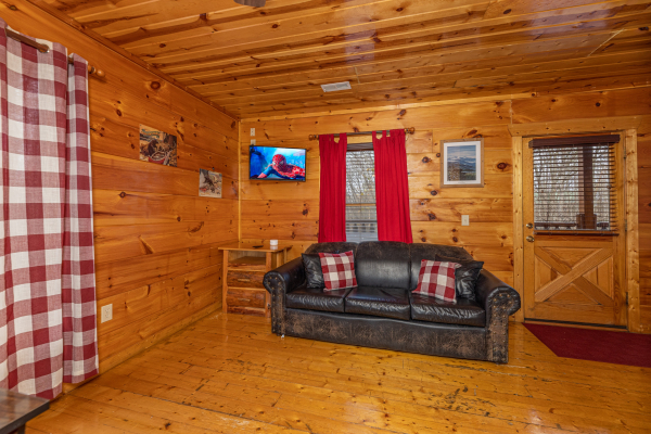 Sleeper sofa in the game room at Dragonfly, a 2 bedroom cabin rental located in Gatlinburg