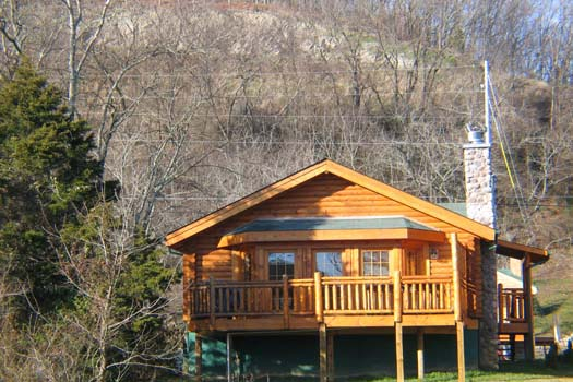 A log cabin with stone stacked chimney called Gone Fishin', a 2-bedroom cabin rental located in Pigeon Forge