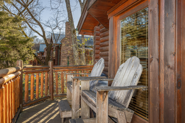 Adirondack chairs on a deck at Gone Fishin', a 2-bedroom cabin rental located in Pigeon Forge