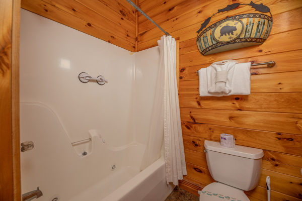 Bathroom with a tub and shower at Gone Fishin', a 2-bedroom cabin rental located in Pigeon Forge