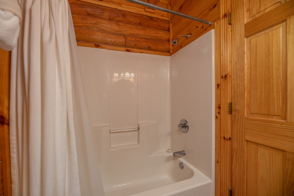 Bathroom with a tub and shower at Gone Fishin', a 2-bedroom cabin rental located in Pigeon Forge
