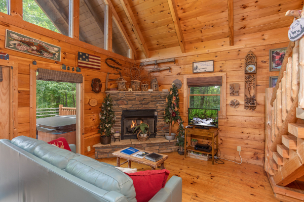 Corner stone fireplace at Aw Paw's Place, a 1-bedroom cabin rental located in Pigeon Forge