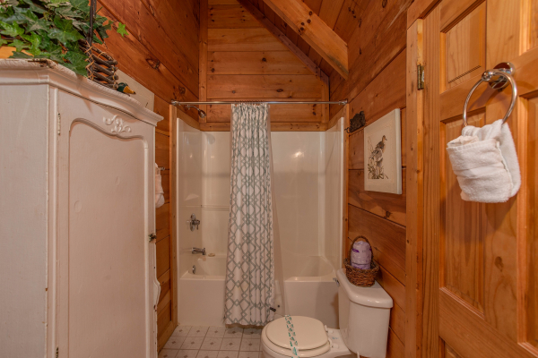 Loft bathroom with tub and shower at Aw Paw's Place, a 1-bedroom cabin rental located in Pigeon Forge