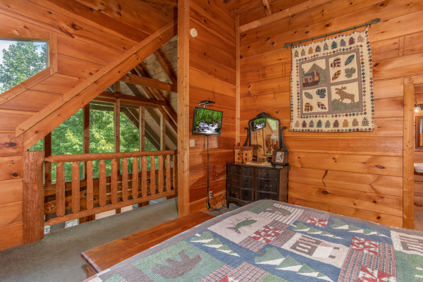 Bedroom with loft views at Aw Paw's Place, a 1-bedroom cabin rental located in Pigeon Forge