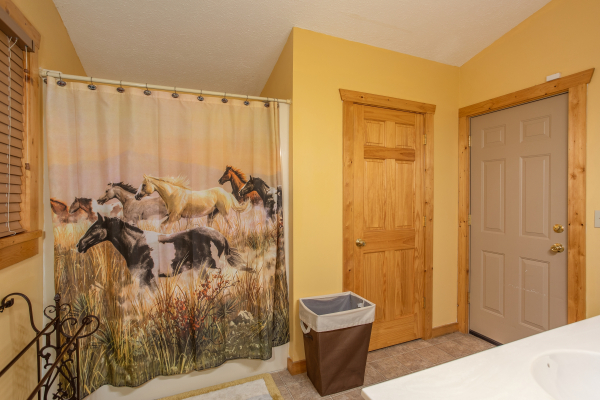 Bathroom with a tub and shower at Alpine Romance, a 2 bedroom cabin rental located in Pigeon Forge