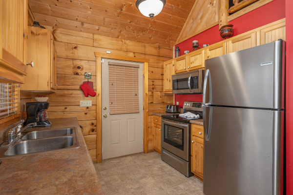 Kitchen with stainless appliances at Alpine Romance, a 2 bedroom cabin rental located in Pigeon Forge