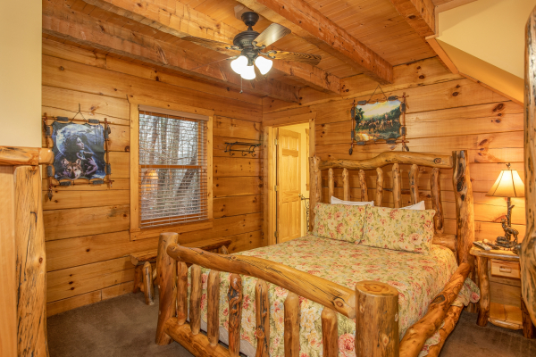 Bedroom with a queen size log bed at Alpine Romance, a 2 bedroom cabin rental located in Pigeon Forge
