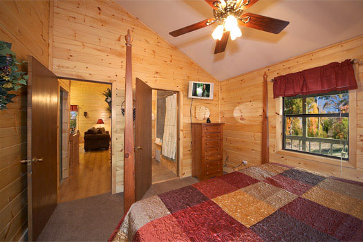 King bedroom with en suite bath at Raccoon's Rest, a 2 bedroom cabin rental located in Pigeon Forge
