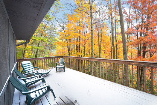Main level deck with seating at Raccoon's Rest, a 2 bedroom cabin rental located in Pigeon Forge