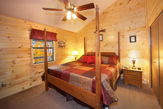 Main level king bedroom at Raccoon's Rest, a 2 bedroom cabin rental located in Pigeon Forge