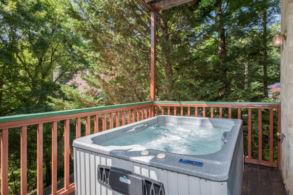 Hot tub on the deck at Ain't Misbehaven, a 1 bedroom cabin rental located in Pigeon Forge