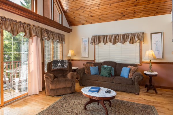 Sofa and recliner at Ain't Misbehaven, a 1 bedroom cabin rental located in Pigeon Forge