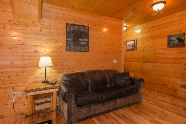 Sofa in the game room at Country Bear's Getaway, a 3-bedroom cabin rental located in Gatlinburg
