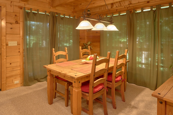 Dining room table with seating for four at A Place to Remember, a 2 bedroom cabin rental located in Gatlinburg
