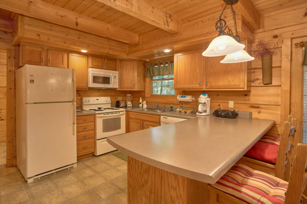 Kitchen with appliances and counter seating at A Place to Remember, a 2 bedroom cabin rental located in Gatlinburg