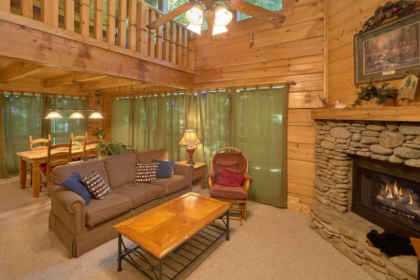 Living room and dining table for four at A Place to Remember, a 2 bedroom cabin rental located in Gatlinburg