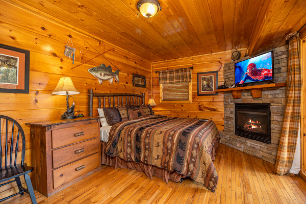 Bedroom with fireplace at The Great Outdoors, a 3 bedroom cabin rental located in Pigeon Forge