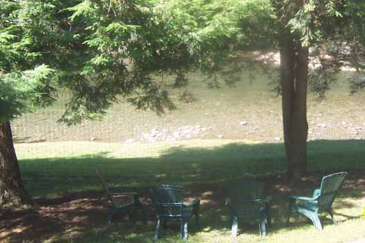 Seating by the river at Dolly's Adorable River Cottage, a 3-bedroom cabin rental located in Pigeon Forge